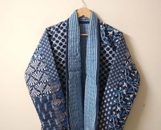 a blue and white jacket hanging on a wall