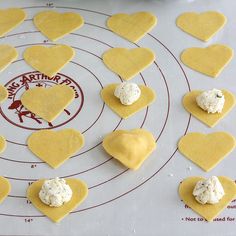 heart shaped cookies are arranged on a baking sheet to make valentine's day treats