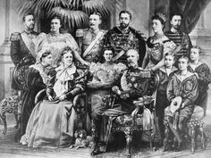 an old black and white photo of a group of people posing for a family portrait