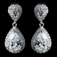 pair of earrings with white stones and clear crystal tears on black background, close up