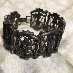 Stunning vintage bronze tone panel bracelet with Egyptian lady motifs.  This bangle is hinged and is suitable for a small to medium size wrist and fits snugly on a medium size wrist. Length is 18cm and width is 3cm. In perfect vintage condition. The hinge clasps securely. Hard to find. Antique Bronze Metal Bracelets, Vintage Bronze Cuff Bracelet With Intricate Design, Antique Bronze Bracelets With Intricate Design, Ornate Metal Bracelets With Antique Finish, Vintage Metal Hinged Cuff Bracelet, Vintage Metal Cuff Bracelet With Hinge, Vintage Copper Bangle, Vintage Metal Bracelets With Antique Finish, Vintage Bronze Metal Bangle