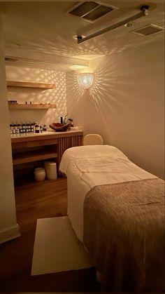 a spa room with a large bed and wooden shelves on the wall, along with other items