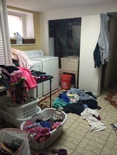 a laundry room filled with lots of clothes and clutter on the floor next to a washer and dryer