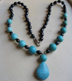 "CHRISTMAS SPECIAL: This is a beautiful turquoise pendant made into a necklace out of turquoise beads and black sea pearls. As seen in the pictures half of the necklace is made from black sea pearls alone and then turns into pearl and turquoise spaced every other one. The turquoise pendant is 1 1/4\" in length and then resting on it is a14mm turquoise bead. The necklace is 18\" in length and is attached together with a silver plated connector clamp." Blue Turquoise Teardrop Necklace With Gemstone Beads, Turquoise Beaded Necklaces With Black Beads As Gift, Gift Turquoise Beaded Necklaces With Black Beads, Turquoise Jewelry With Black Beads For Gift, Elegant Turquoise Jewelry With Black Beads, Turquoise Necklace With Black Beads As Gift, Blue Necklace With Black Beads For Gift, Bead Necklaces, Necklace Ideas