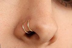 a close up of a person with a nose ring on their nose and the bottom part of her nose