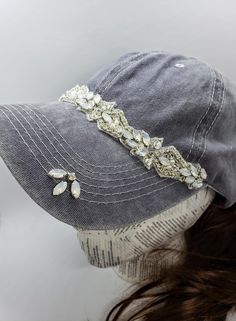 This is a new product from Handmade MKE! This is a distressed gray one size fits all baseball cap with a hole for your ponytail in the back, it is also adjustable. On the front of the hat is band of clear rhinestones, marquise opal stones, sequins and beads. On the brim of the hat are three more opals and a single circular rhinestone. This is very comfortable, and great to throw on with a plain white T-shirt! Like our Facebook Page and get 10% off when you message me before checkout! Everything Adjustable Silver Cap, Silver Adjustable Cap, Adjustable Rhinestone Baseball Cap With Curved Brim, Silver Hat With Adjustable Fit And Short Brim, Silver Adjustable Hat With Short Brim, Adjustable Brimmed Gray Baseball Cap, Adjustable Silver Snapback Baseball Cap, Adjustable Silver Baseball Cap, Silver Adjustable Snapback Baseball Cap