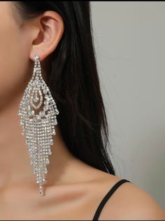 Make a dazzling statement with VALENTINA Chandelier rhinestone Statement Evening Earrings! These earrings are designed to captivate and command attention. Featuring clear rhinestones on a stunning silver base, they exude a sense of elegance and glamour. With a length of 5.9" (14.98cm) and a width of 1.8" (4.57cm), these earrings are designed to stand out and elevate your stage presence. The post back with a push back circle closure ensures a secure and comfortable fit, allowing you to strike you Evening Earrings, Stage Presence, Inner Goddess, Rhinestone Bracelet, All That Glitters, Clear Rhinestones, Chandelier Earrings, Bracelet Sizes, Clear Crystal