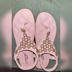 Women's Pink/Blush Ashley Blue Comfort Sandals. The Shoes Are Size 10 (40.5) And The Condition Is Excellent As They're New With No Tags And Will Not Come In The Original Box Or Packaging. The Upper Material Is Accented With Thongs For Comfort Between The Toes. The Faux Diamonds Are Encased And Secured By Rose Gold Flowers. The Backstrap Is Elastic And The Inner Sole Has Comfy Quilted Cushions. Pink Flat Heel Flip Flops For Spring, Spring Pink Flat Heel Flip Flops, Pink Synthetic Flat Heel Flip Flops, Pink Flat Synthetic Flip Flops, Pink Cushioned Slip-on Flip Flops, Spring Pink Flip Flops With Cushioned Footbed, Pink Cushioned Flip Flops For Spring, Spring Pink Cushioned Flip Flops, Pink Toe Post Synthetic Flip Flops