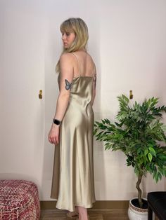 A beautiful gold slip dress, in a thick satin material, that shimmers and shines with movement. A beautiful dress for a wedding, rehearsal dinner, or cocktail party. Champagne Gold Silk Slip Dress V-Neckline, double layer fabric over bust Heavy Satin Material Gold V-neck Evening Dress For Summer, Silk V-neck Slip Dress For Prom, Elegant Gold Shimmer Evening Dress, Gold Spaghetti Strap Evening Dress For Wedding, Gold Spaghetti Strap Dress For Formal Occasions, Bias-cut Satin Evening Dress For Date Night, Gold Spaghetti Strap Dress For Wedding, Elegant Shimmer V-neck Evening Dress, Bias Cut Satin Evening Dress For Date Night