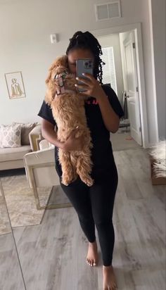 a woman taking a selfie while holding a dog