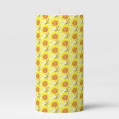 a yellow and white flower pattern candle