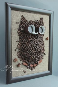 an owl made out of coffee beans with glasses on it's face and eyes