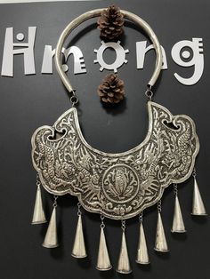 Hmong Silver Necklace,Vintage Lucky symbol Design,Sweater detective,Miao Silver ,Tribal Necklace ,Boho Style, This necklace is handmade craft by our family lived in minority area Southwest of China. It's very unique. Also can bring you much luck. The top and bottom is hmong silver carved signs.  It can be a special gift. Width: 27cm Height:29cm Weight: 30g Care Instruction:  ❥. Avoid wearing the same miao silver jewelry for a long time.Take off your jewelry before bathing or swimming. ❥. Miao silver jewelry should avoid rubbing against each other and scratch the flower surface. ❥. Use soft brush or cotton cloth to wipe the surface of jewelry, so as to remove surface stains. ❥. When not wearing, it should be sealed and packed to reduce contact with air and avoid oxidation of miao silver jew Traditional White Oxidized Finish Necklace, Hmong Modern Jewelry, Sterling Silver Amulet Necklace With Oxidized Finish, Antique Silver Amulet Necklace With Oxidized Finish, Silver Jews, Hmong Necklace Silver, Antique Silver Oxidized Amulet Jewelry, Miao Silver, Lucky Symbols