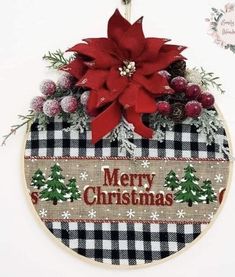 a cross stitch christmas ornament with poinsetti