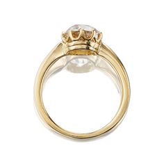 a gold ring with a white diamond in the center and two diamonds on each side