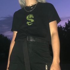 "Dragon T-shirt. High-quality classic cut T-shirt with a neon green dragon embroidery, designed by us and made in Poland. The model is 168 cm (5'6\") and wears size L. JOIN US ON INSTAGRAM 🌹 http://instagram.com/blvck.pl 🏷 PRODUCT DETAILS 🏷 Embroidery Crew neck 100% High-quality Cotton Made in Poland 📏 SIZING & FIT 📏 All our sweatshirts and T-shirts are unisex. Measurements (width/length) XS - 49/64 cm (19\"/25\") S - 51/68 cm (20\"/27\") M - 53/70 cm (21\"/27.5\") L - 55/72 cm (21.5\"/ Grunge Crew Neck Shirt For Streetwear, Short Sleeve Tops With Embroidered Graphics For Streetwear, Embroidered Short Sleeve Tops For Streetwear, Alternative Style Cotton Crew Neck Shirt, Alternative Style Crew Neck Cotton Shirt, Alternative Cotton Crew Neck Shirt, Short Sleeve T-shirt With Embroidered Graphics For Streetwear, Fitted Casual T-shirt With Embroidered Graphics, Embroidered Relaxed Fit T-shirt For Streetwear