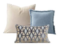 three pillows with different patterns on them, one in blue and the other in beige