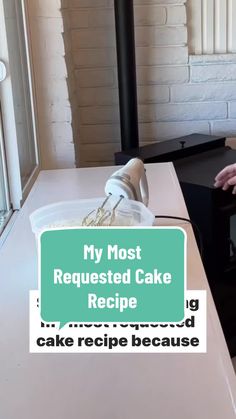 a woman sitting at a table with a cake in front of her and the words, my most requested cake recipe