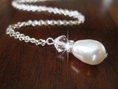 a necklace with a white pearl on it