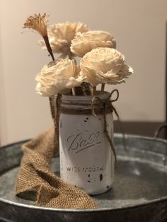 some flowers are in a mason jar on a table