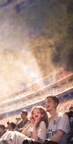 two people sitting next to each other in front of a crowd at a baseball game