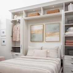 a bedroom with white walls and shelves filled with linens, blankets and other items