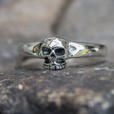 *  Simple yet effective skull ring*  Hand made in our workshops in Devon*  .925 fully hall marked sterling silver ring*  Available in J - X*  Special Sizes are available on request Sterling Silver Skull Print Rings As Gift, Sterling Silver Rings With Skull Print For Gift, Gothic Skull Ring In Sterling Silver White Gold, Sterling Silver Skull Ring In White Gold, Gothic Silver Sterling Silver Skull Ring, Adjustable Sterling Silver Skull Ring With Engraving, Adjustable Engraved Sterling Silver Skull Ring, Adjustable Sterling Silver Skull Ring, Engraved White Gold Skull Ring In Sterling Silver