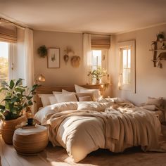 a large bed sitting in a bedroom next to two potted plants on top of a wooden floor