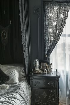 a black and white photo of a bedroom with an old fashioned dresser, bed, and curtains