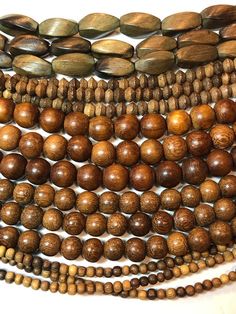 16" full strand of natural Robles wood beads.  Made in the Philippines.They are round in shape but not perfectly round.  The beads on each strand are uniform.Hole sizes:     5mm   - 1mm     6mm   - 1mm     8mm   - 2mm     10mm - 3mmFind more natural bead strands here: https://www.etsy.com/shop/thebeadgalleryA2Processing time:1-3 daysShipping:2-5 days standard USPS shipping methods Rustic Wooden Beads, Rustic Round Wooden Beads, Earthy Wooden Beaded Necklaces, Wooden Beads Necklace With Round Beads, Natural Wood Jewelry With Round Wooden Beads, Natural Wood Color Jewelry With Round Wooden Beads, Brown Wooden Beaded Necklace With Round Beads, Wooden Beaded Necklaces With Round Beads, Medium Brown