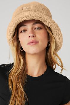 The iconic bucket hat just got a Sherpa update! Top off your cool-weather look with this plush Sherpa bucket hat, featuring a full, textured brim. Plush sherpa (faux fur) Center front woven patch Alo logo