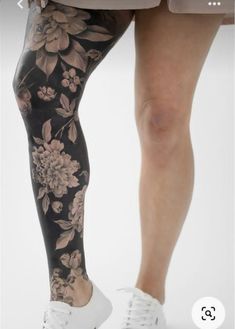 a woman's legs with flowers on them