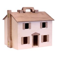 a wooden toy house with windows and doors