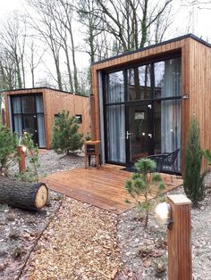 a couple of small wooden buildings sitting in the middle of a forest