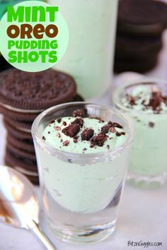 mint oreo pudding shots with chocolate cookies in the background