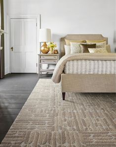 a bedroom with a large bed and white walls