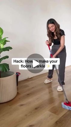 a woman is cleaning the floor with a mop