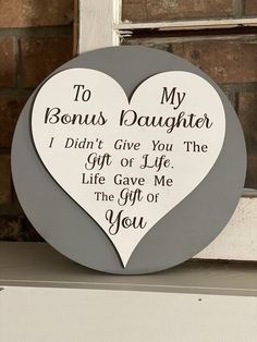 a heart shaped plaque that says to my son's daughter i didn't give you the gift of life