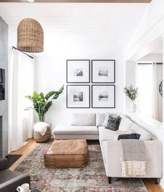 a living room filled with furniture and pictures on the wall