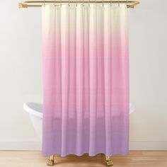 a pink and purple shower curtain hanging on a bathtub next to a white tub