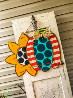 a door hanger with two sunflowers on it