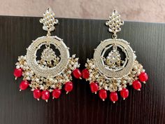 Red Jhumka Kundan Earrings. Handcrafted pair of earrings. Gives a traditional look. Can be worn for engagement and wedding parties. Indulge in it or gift it and watch the compliments flow! It is advisable to store jewelry in a zip lock pouch (air tight pouch), keep away from water perfume and other chemicals and clean it with soft cloth. FREE SHIPPING!! Red Earrings Indian, Punjabi Jhumka, Red Jhumka, Dark Red Earrings, Pakistani Earrings, Earrings Kundan, Nose Pins, Red Indian, Water Perfume