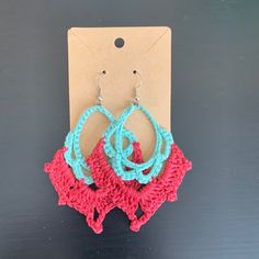 two pairs of crocheted hoop earrings on top of a carded hanger