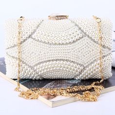 The Violeta Luxury Pearl Clutch Bag has a stunning and luxurious look. This bag is made of high-quality materials and has enough space for your essentials while still looking elegant at the same time. Its embroidered exterior bespeaks its beauty, while its exquisite frame demonstrates luxury. Exclusively available in c Elegant White Handheld Box Bag, Luxury Pouch Bag With Pearl Handle, Luxury Rectangular Box Bag With Pearl Handle, Luxury Evening Clutch With Pearl Handle, Luxury Pearl-embellished Clutch For Formal Occasions, Luxury Bags With Pearl Handle, White Evening Clutch Box Bag, Luxury Bag With Pearl Handle, Rectangular Shape, Luxury Rectangular Bag With Pearl Handle