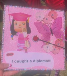 a person holding up a card with a girl in a graduation cap and butterfly on it