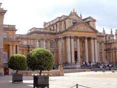 an old building with two trees in front of it