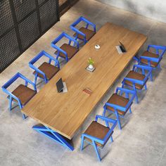 an overhead view of a wooden table with blue chairs