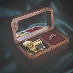 an open wooden box with jewelry inside