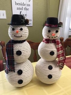 two snowmen sitting on top of a table