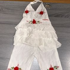 100% Cotton White Halter Top With The Matching Pants Rose Embroidery Detail The Size Says Large On The Tag. I Would Say This Outfit Would Fit Between A Size 2 To 4t. It’s An Excellent Condition Never Worn Without Tags. Cute White Summer Pants, White Halter Top, Red Embroidery, Rose Embroidery, Cotton Set, Embroidery Details, Halter Top, Two Piece, Red And White